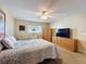 Bedroom featuring carpet floors, a ceiling fan, closet, and natural light at 9336 Santa Monica Way, New Port Richey, FL 34655
