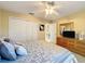 Bedroom featuring ceiling fan, closet, and dresser at 9336 Santa Monica Way, New Port Richey, FL 34655