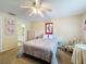Bedroom with carpet floors, a ceiling fan, closet, and natural light, and view to the bathroom at 9336 Santa Monica Way, New Port Richey, FL 34655