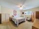 Cozy bedroom with carpet floors, a ceiling fan, closet, and natural light at 9336 Santa Monica Way, New Port Richey, FL 34655