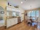 Dining area featuring wood floors, cabinetry, a window overlooking the exterior and a view to the kitchen at 9336 Santa Monica Way, New Port Richey, FL 34655