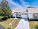 Aerial view of a single-story home with a well-manicured lawn, a long driveway, and a two-car garage at 9336 Santa Monica Way, New Port Richey, FL 34655
