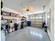 View of a spacious garage with shelving, storage, and a clean, epoxy-coated floor at 9336 Santa Monica Way, New Port Richey, FL 34655