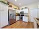 Bright kitchen featuring stainless steel appliances, granite countertops and white cabinets at 9336 Santa Monica Way, New Port Richey, FL 34655