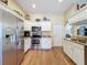 Kitchen with stainless steel appliances, granite countertops, wood floors, and white cabinets at 9336 Santa Monica Way, New Port Richey, FL 34655