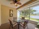 Enclosed lanai with a decorative ceiling fan and lake view at 9336 Santa Monica Way, New Port Richey, FL 34655