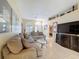 Inviting living room with tile floors, comfortable seating, and a decorative upper shelf at 9336 Santa Monica Way, New Port Richey, FL 34655