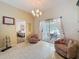 Bright seating area with tile flooring, a chandelier, and sliding doors that lead to an outdoor patio at 9336 Santa Monica Way, New Port Richey, FL 34655