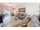 Cozy living room featuring tile flooring, comfortable couches, and access to the outdoor patio at 9336 Santa Monica Way, New Port Richey, FL 34655