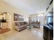Spacious living room with tile flooring, comfortable seating, and large windows for natural light at 9336 Santa Monica Way, New Port Richey, FL 34655