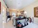 Open-concept living room with tile flooring, comfortable couches, and access to the outdoor patio at 9336 Santa Monica Way, New Port Richey, FL 34655