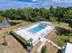 A refreshing community pool surrounded by lounge chairs and lush greenery at 9336 Santa Monica Way, New Port Richey, FL 34655