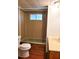 Compact bathroom featuring a toilet, shower, and vanity for essential needs at 9441 Teak St, New Port Richey, FL 34654