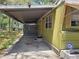Side view of the home showing the carport at 9441 Teak St, New Port Richey, FL 34654