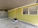 View of the home's entrance with covered carport at 9441 Teak St, New Port Richey, FL 34654