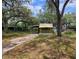 Exterior view of the home, showing the carport and surrounding landscaping at 9441 Teak St, New Port Richey, FL 34654