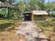 A one-story home with mature trees and a driveway at 9441 Teak St, New Port Richey, FL 34654