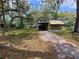 Single-story home with large trees and long driveway at 9441 Teak St, New Port Richey, FL 34654