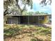 Charming single-story home with green siding and a covered patio at 9441 Teak St, New Port Richey, FL 34654