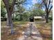 Gated property with a long driveway, mature trees, and plenty of space for outdoor enjoyment at 9441 Teak St, New Port Richey, FL 34654