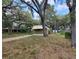 Quaint home with a covered carport and mature trees offering ample shade on a spacious lawn at 9441 Teak St, New Port Richey, FL 34654