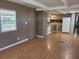 Open kitchen with white appliances, grey cabinets, and hardwood floors at 9441 Teak St, New Port Richey, FL 34654