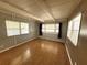Bright living room featuring hardwood floors and multiple windows for natural light at 9441 Teak St, New Port Richey, FL 34654