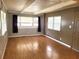 View of the living room features three windows and neutral paint at 9441 Teak St, New Port Richey, FL 34654