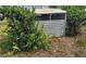 Exterior chicken coop nestled among greenery, offering a rustic touch to the outdoor space at 9441 Teak St, New Port Richey, FL 34654