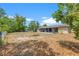 Fenced backyard featuring mature trees, a fire pit and a screened in porch at 9640 Northcliffe Blvd, Spring Hill, FL 34608