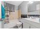 Well-lit bathroom featuring modern fixtures, a shower-tub combination and ample vanity space at 9640 Northcliffe Blvd, Spring Hill, FL 34608