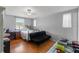 Cozy bedroom with hardwood floors, natural light, ceiling fan and comfortable seating at 9640 Northcliffe Blvd, Spring Hill, FL 34608