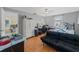 Comfortable bedroom featuring hardwood floors, natural light, and a ceiling fan at 9640 Northcliffe Blvd, Spring Hill, FL 34608
