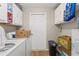 Functional laundry room with washer, dryer, and additional storage cabinets at 9640 Northcliffe Blvd, Spring Hill, FL 34608