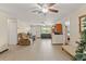 Spacious living room featuring tile floors, neutral paint, ceiling fans, and comfortable seating for relaxing and entertaining at 9640 Northcliffe Blvd, Spring Hill, FL 34608