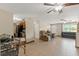 Spacious living room with tile flooring, multiple ceiling fans, and access to kitchen and front entrance at 9640 Northcliffe Blvd, Spring Hill, FL 34608