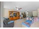 Comfortable living room with tile floors, a ceiling fan, and entertainment center at 9640 Northcliffe Blvd, Spring Hill, FL 34608