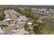 Aerial view of the neighborhood with cozy houses, serene lakes, and lush greenery at 9652 Oakwood Hills Ct, New Port Richey, FL 34655