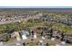 Aerial view of residential neighborhood showcasing homes, mature trees, and a tranquil pond at 9652 Oakwood Hills Ct, New Port Richey, FL 34655
