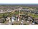 Aerial view of home situated in residential neighborhood showcasing homes, mature trees, and a tranquil pond at 9652 Oakwood Hills Ct, New Port Richey, FL 34655