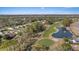 Golf course community aerial showcasing pond, course, and neighborhood with lush greenery at 9652 Oakwood Hills Ct, New Port Richey, FL 34655