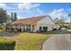 A charming back exterior featuring a patio with seating, well-maintained lawn, and lush greenery at 9652 Oakwood Hills Ct, New Port Richey, FL 34655