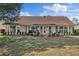 Expansive backyard with multiple windows, patio seating, and a well-kept lawn and landscape at 9652 Oakwood Hills Ct, New Port Richey, FL 34655