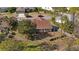 The backyard is shown from above featuring green lawn, trees, landscaping and patio at 9652 Oakwood Hills Ct, New Port Richey, FL 34655