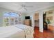 Bright bedroom with ceiling fan, shuttered windows, and walk-in closet entrance at 9652 Oakwood Hills Ct, New Port Richey, FL 34655