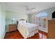 Cozy bedroom with large window, wood floors, and neutral decor at 9652 Oakwood Hills Ct, New Port Richey, FL 34655