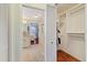 Walk-in closet with ample shelving seen from bathroom at 9652 Oakwood Hills Ct, New Port Richey, FL 34655