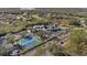 Aerial view of community clubhouse featuring tennis courts and parking surrounded by mature landscaping at 9652 Oakwood Hills Ct, New Port Richey, FL 34655