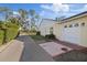 Exterior view showcasing the garage, driveway, and partial landscaping at 9652 Oakwood Hills Ct, New Port Richey, FL 34655