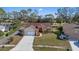 Inviting single-story home with a manicured lawn, driveway, and mature trees in a serene neighborhood setting at 9652 Oakwood Hills Ct, New Port Richey, FL 34655
